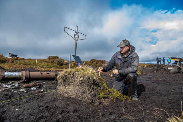 Tim Fletcher from Geoscope Services pays his respects during the search for lost WWII American airman Corporal Clarence Watson at Twizle Head Moss Crash Site on Holme Moss near Holmfirth. On 9 October 2026 it was 82 years to the date a B-24H Liberator aircraft 'Sack Time' crashed on a hillside during a training flight in poor visibility, killing all but one of the people onboard. Picture by Tony Johnson.