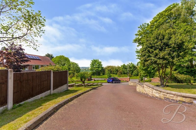 The winding driveway that leads to what could be your dream home. It also leads to beautifully landscaped gardens, a maintained lawn, a double garage and off-street parking for lots of vehicles.