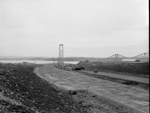 The construction of the Forth Road Bridge approach road, near Dalmeny, with the Forth Bridge in the background, in October 1961