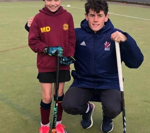 English international field hockey player, Tom Sorsby,  who plays as a midfielder for the England and Great Britain pictured with junior members of Chapeltown Hockey Club