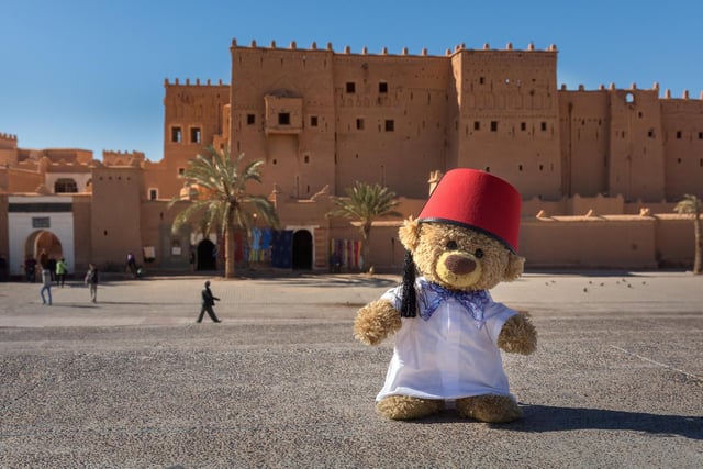 John James the teddy bear as a tourist guide in Ouarzazate, Morocco. 
These adorable teddy bears could be the world's most well-travelled cuddly toys - as their photographer owner has chronicled their adventures in 27 different countries. Christian Kneidinger, 57, has been travelling with his teddy bears, named John and Bob since 2014 - and his taken them to some of the world's most famous landmarks. The teddy bears have dressed up in traditional Emirati clothing to visit the Sultan's Palace in Oman, and have braved the cold on a glacier on Lofoten Island in Norway.
