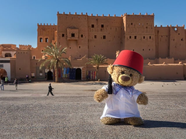 John James the teddy bear as a tourist guide in Ouarzazate, Morocco. 
These adorable teddy bears could be the world's most well-travelled cuddly toys - as their photographer owner has chronicled their adventures in 27 different countries. Christian Kneidinger, 57, has been travelling with his teddy bears, named John and Bob since 2014 - and his taken them to some of the world's most famous landmarks. The teddy bears have dressed up in traditional Emirati clothing to visit the Sultan's Palace in Oman, and have braved the cold on a glacier on Lofoten Island in Norway.