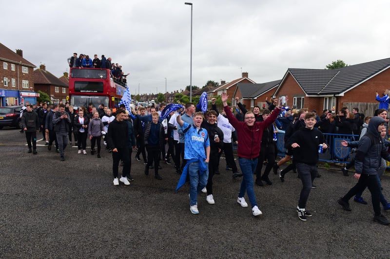 Fans walking alongside the Hartlepool United open topped bus parade as the procession arrives at the Brus roundabout.