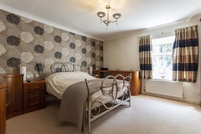 This good sized room has fitted wardrobes, base and drawer units and looks out over the rear of the property.