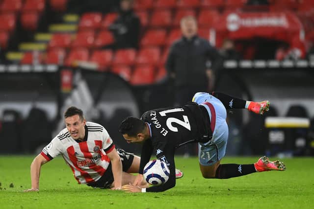 SHEFFIELD, ENGLAND - MARCH 03: Anwar El Ghazi of Aston Villa is challenged by Phil Jagielka of Sheffield United leading to a red card being shown during the Premier League match between Sheffield United and Aston Villa at Bramall Lane on March 03, 2021 in Sheffield, England. Sporting stadiums around the UK remain under strict restrictions due to the Coronavirus Pandemic as Government social distancing laws prohibit fans inside venues resulting in games being played behind closed doors. (Photo by Clive Mason/Getty Images)