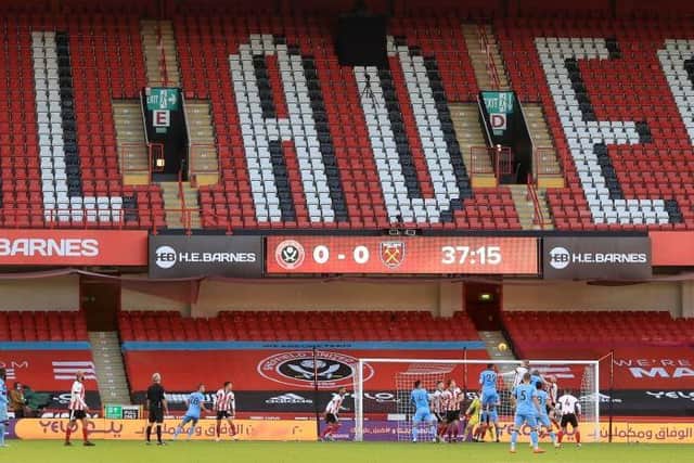 Sheffield United defend an attack in front of empty stands during the Premier League football match between Sheffield United and West Ham United at Bramall Lane (Photo by MIKE EGERTON/POOL/AFP via Getty Images)