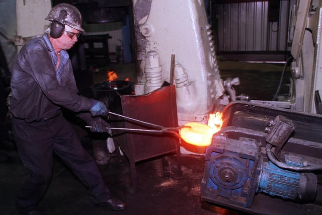 Paul Luff on the tongs at the 5ocwt stamp furnace in the Stamp and Lasco department, at Daniel Doncasters, Penistone Road 1999