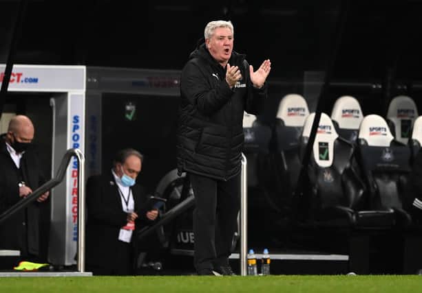Newcastle manager Steve Bruce applauds his team from the sideline during the Premier League match between Newcastle United and Wolverhampton Wanderers at St. James's Park on February 27, 2021.