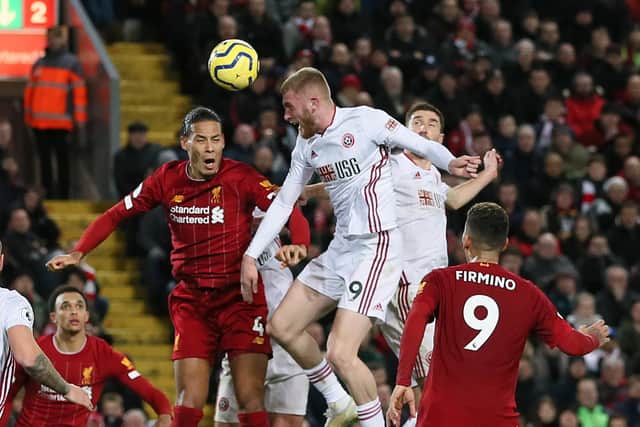Oliver McBurnie of Sheffield United and Virgil Van Dijk of Liverpool go to head the ball: James Wilson/Sportimage