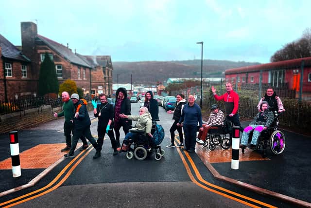A new road crossing has been introduced on Burton Street in Hillsborough tomake the area safer for people with disabilities who use nearby communityspaces.
We recently had a crossing completed to aid our clients at Burton Street – who have moderate to profound learning difficulties/disabilities – cross between sites. We reimagined the famous Beatles shot on Abbey Road to commemorate it.