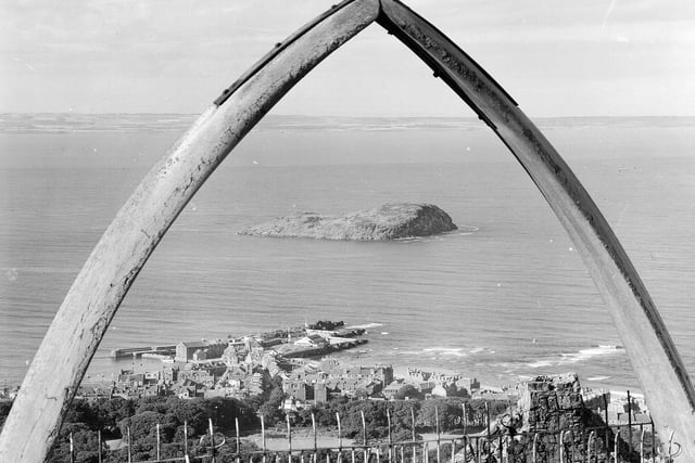 Craigleith Island at North Berwick framed by whale's jawbone on top of North Berwick Law.
the jawbone was removed in 2005 - for safety reasons - but was replaced with a fiberglass replica