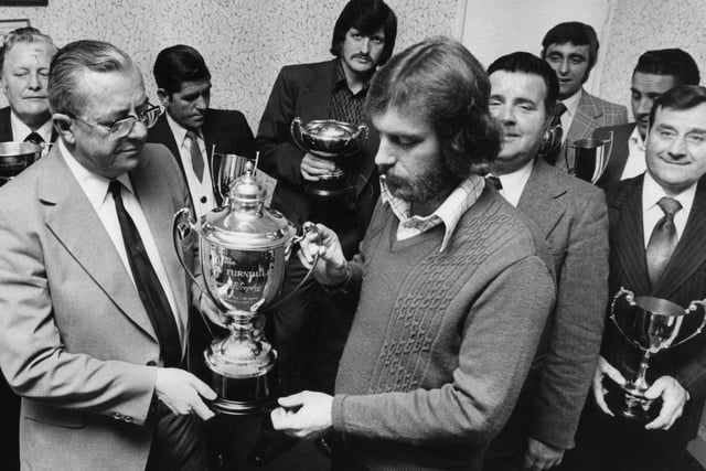 Winners of the Five and Three League receive their trophies in the Perseverance Club in 1977.
