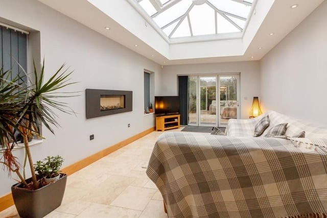 And so on to the orangery extension at the Parkland Close property which can only be described as spectacular. A beautiful space for either relaxing or entertaining, it comes complete with a travertine tiled floor, contemporary, wall-mounted gas fire and 12 ceiling spotlights.