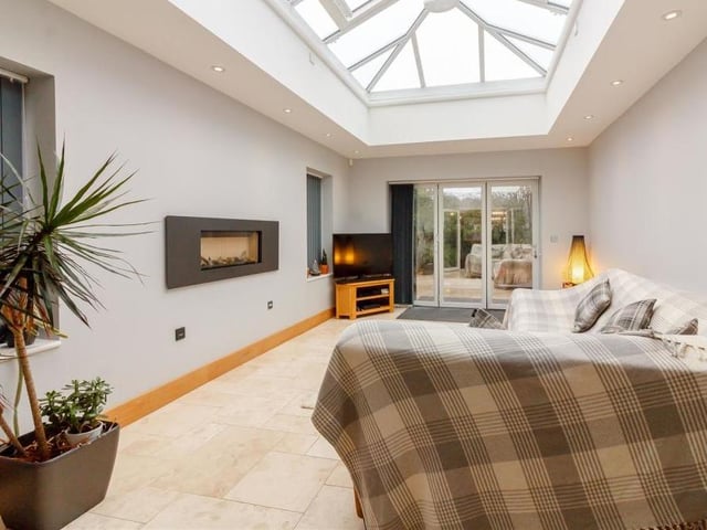 And so on to the orangery extension at the Parkland Close property which can only be described as spectacular. A beautiful space for either relaxing or entertaining, it comes complete with a travertine tiled floor, contemporary, wall-mounted gas fire and 12 ceiling spotlights.