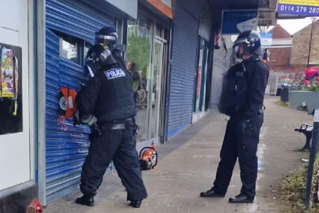 Officers cut their way into the former food shop on Manchester Road