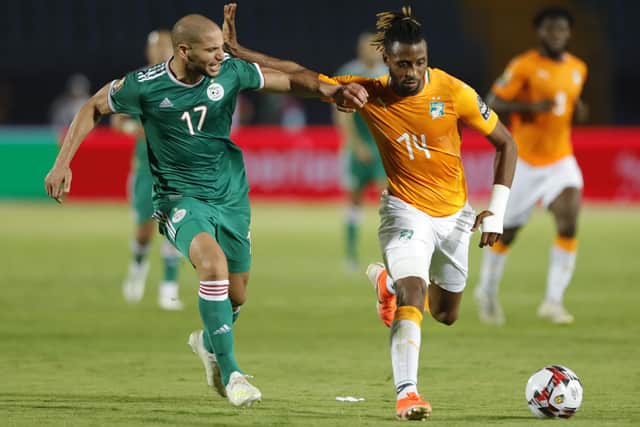 Algeria's midfielder Adlene Guedioura fights for the ball with Ivory Coast's forward Jonathan Kodjia during the 2019 Africa Cup of Nations.
