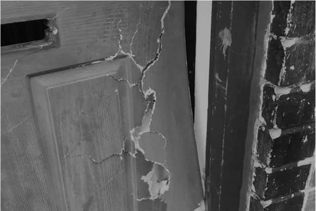 A damaged front door after a police raid in Sheffield