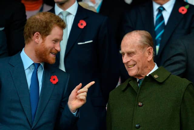 Britain's Prince Harry (L) speaks with his grandfather Prince Philip  (Photo by GLYN KIRK / AFP) (Photo by GLYN KIRK/AFP via Getty Images)