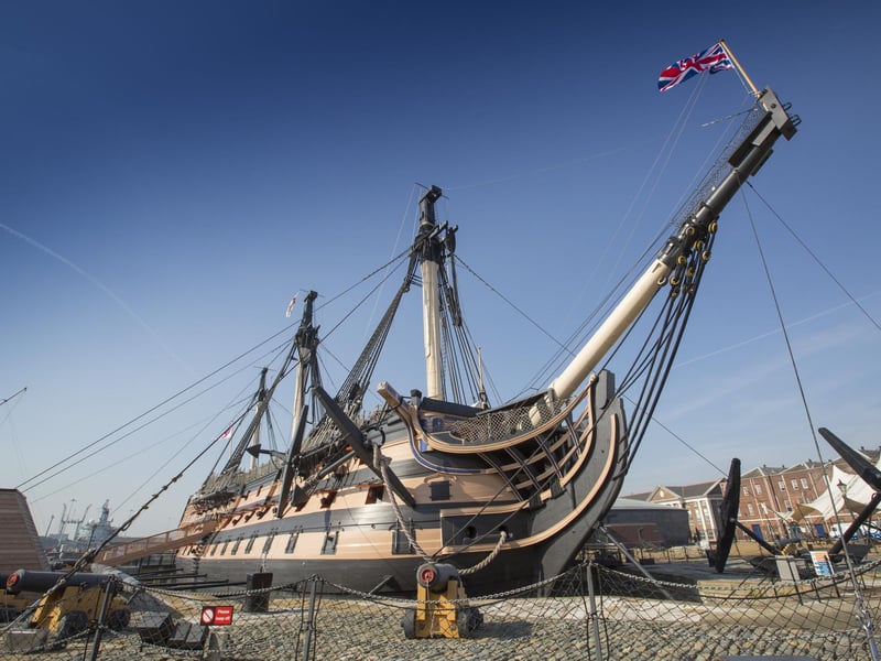 Lord Nelson’s flagship in the Battle of Trafalgar was launched from Chatham in 1775 but based in Portsmouth. HMS Victory was heavily damaged in the Battle of Trafalgar, which took place off the coast of Spain, suffering casualties and needing repairs. Nelson himself also suffered a fatal wound and died in the ship's cockpit. After the battle, she was towed to Gibraltar for repairs and continued to serve in various roles, including troop transport and housing prisoners. As a result of the city's links with the ship she is now permanently docked in Portsmouth in the historic dockyard where she is a key tourist attraction. HMS Victory is the oldest commissioned warship in the world and serves as the flagship of the First Sea Lord and Chief of Naval Staff.