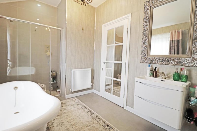 The family bathroom boasts a roll top bath and built in shower.