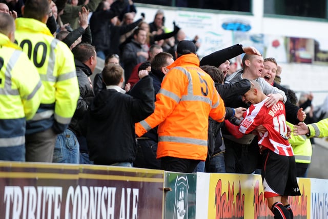 Danny Webber celebrates with fans after scoring for United at Plymouth in 2009