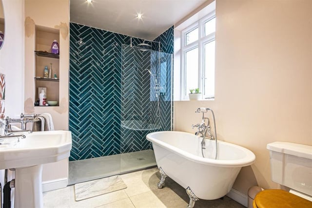 The family bathroom is described as luxurious, with a generous shower enclosure framed by feature tiling.