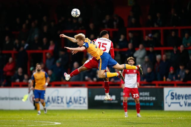 Mansfield Town midfielder George Lapslie goes up for the ball.