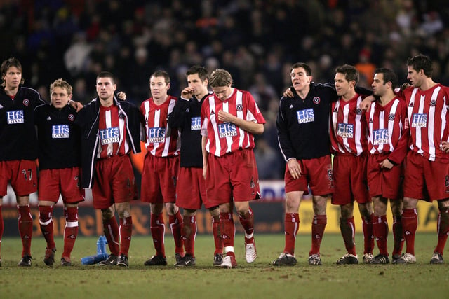 Tense United players watch on during the penalty shoot-out against Arsenal at the end of the FA Cup fifth round replay at Bramall Lane in March 2005.