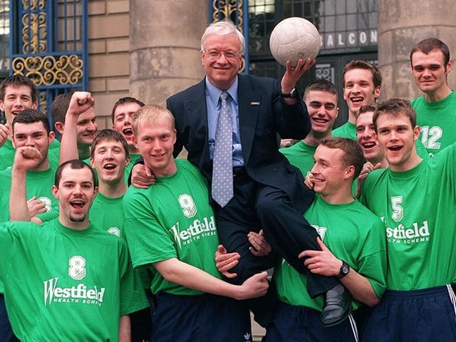 Chairman of Westfield Health, Graham Moore, is hoisted aloft outside the City Hall by members of the Sheffield Volleyball Team after presenting them with new kit, on April 1, 1998