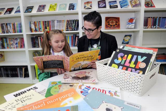 School Librarian Anna Tomlinson pictured reading with a pupil at Valley Park Primary School before lockdown