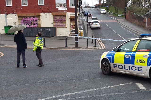 Police give directions to a member of the public at the cordon on Burngreave Road, Sheffield