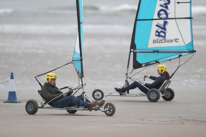 A photo of the couple enjoying a shot at land yachting on St Andrews beach during their trip which involved meeting with students at the university and taking part in various activities.