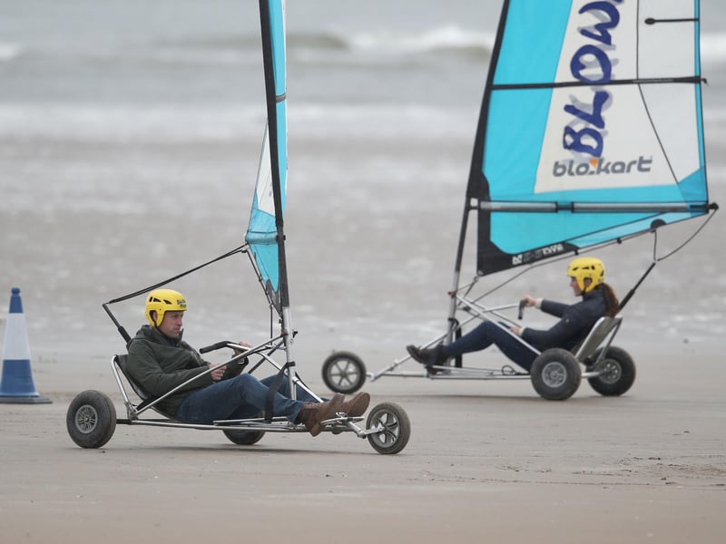 A photo of the couple enjoying a shot at land yachting on St Andrews beach during their trip which involved meeting with students at the university and taking part in various activities.