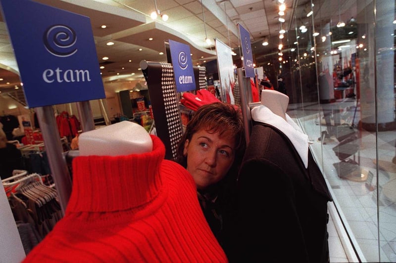 A shop worker sorts the window displays at Etam when the centre first opened