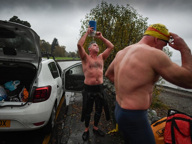 Open water swimming enthusiasts pour warm water over themselves following an early morning swim in Loch Lomond ,Trossachs, Scotland. A new study from the UK Dementia Research Institute found that the blood of regular winter swimmers contains a "cold-shock" protein that wasn't found in that of people who did other cold-weather exercise on dry land. This protein has elsewhere been shown to slow the onset of dementia and even repair damage it causes in mice.