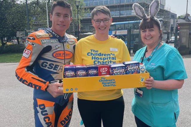 James Toseland with a volunteer and a member of hospital staff.