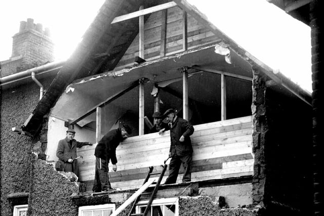 Our picture shows workmen boarding up the front of a house in Crookes after the gales had blown out the complete bedroom wall at the front of the house in  February 1962