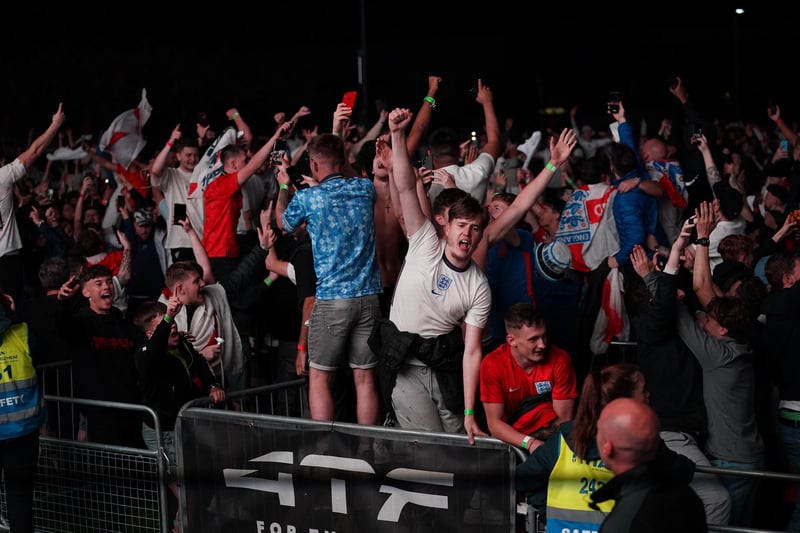 Fans in Manchester celebrate England qualifying for the Euro 2020 final as they watch the semi final match between England and Denmark.