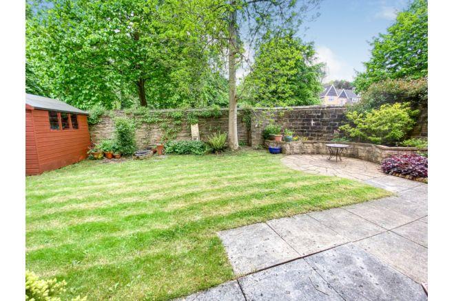 At the back of the house is a south facing walled garden, with paved patio, lawn, planted beds, beautiful mature trees and garden shed.