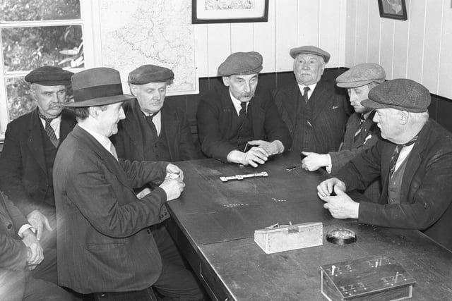 The over-65 members of the Burn Park Recreation Hut spent each day enjoying their game of dominoes. Here they are in September 1940.