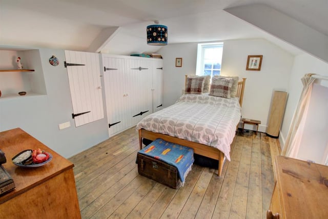 The second double bedroom overlooks the front of the property. There are further cottage style built in cupboards.