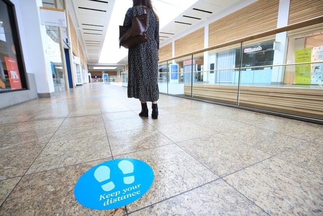 Floor signs telling people to maintain a two-metre distance at all times are dotted around the centre.