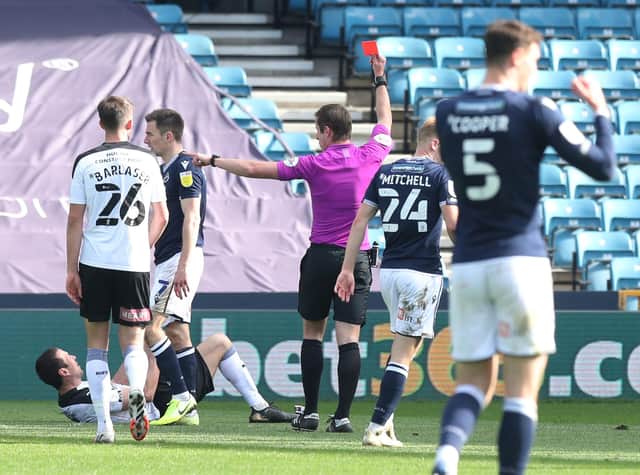 Rotherham United's Richard Wood (on the ground) is shown the red card during the Sky Bet Championship match at The Den. Jonathan Brady/PA Wire.