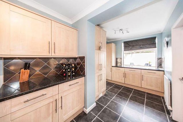 A modern kitchen is located at the rear of the property and leads through to a bedroom which is currently being used as a dining area.