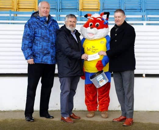 Stocksbridge Park Steels hand money raised by the club during the Christmas Food Bank Drive to Ian Lucraft. Pictured from L-R, Stocksbridge Park Steels Commercial Director Roger Gissing; Methodist Minister for Stocksbridge, Crane Moor and Green Moor Ian Lucraft; Stocksbridge Park Steels mascot Sammy the Fox and Stocksbridge Park Steels Chairman Graham Furness.