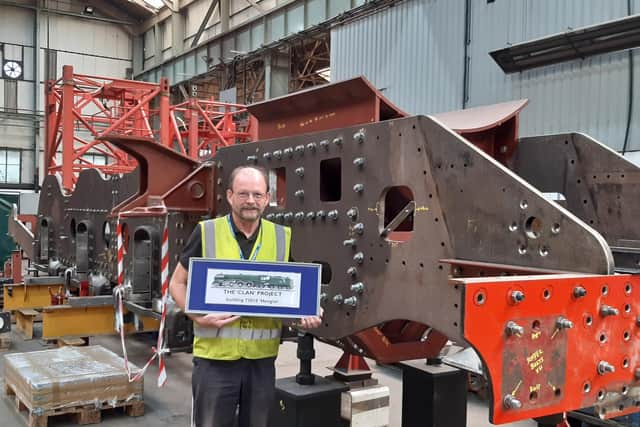 Engineering director Geoff Turner stands in front of the chassis for the the Hengist.