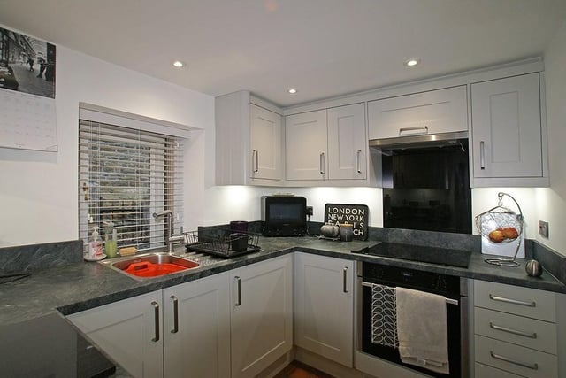 The kitchen is fitted with a range of modern Shaker-style cupboards.