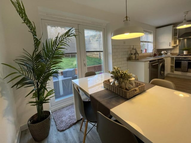 So let's start our tour of the property with the stylish kitchen/diner. This is the well-presented dining section of the room, which features double-glazed French doors opening out on to the back garden.