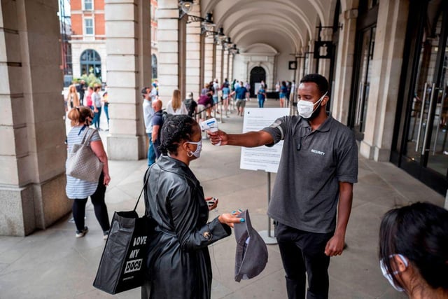 Security took the temperature of shoppers at an Apple store in Covent Garden in London before they entered.