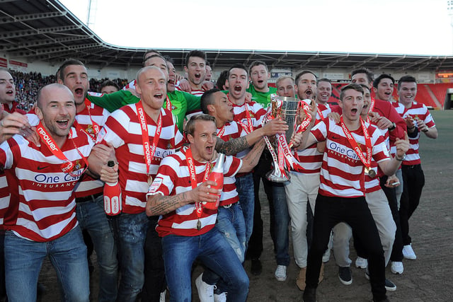 The Rovers squad celebrate promotion and the League One title